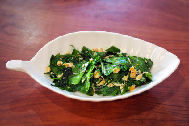 istock A white plate of delicious stir-fried Baegu leaf or Gnetum gnemon or Melinjo with egg. 1205924607