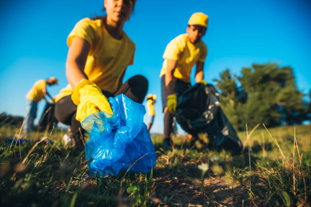 istock People cleaning up garbage in nature 1205928304