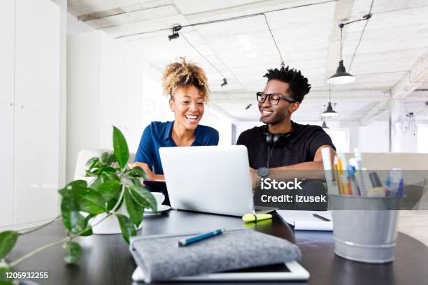 Businesswoman And Businessman Planning Over Laptop Stock Photo - Download Image Now - 30-34 Years, Adult, Adults Only