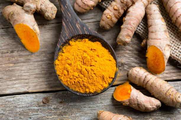 istock Curcuma longa, powder and rhizomes 1205934202