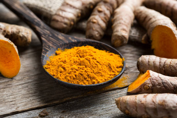 istock Curcuma longa, powder and rhizomes 1205934384