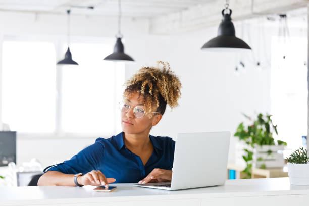 istock Thoughtful female executive looking away at office 1205934535