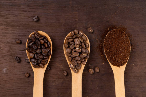 istock Roasted coffee in a spoon on the table Coffee on wood 1205934883