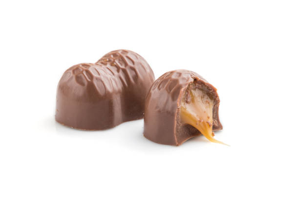 istock Chocolate caramel candies isolated  on white background. Side view, close up. 1205935050