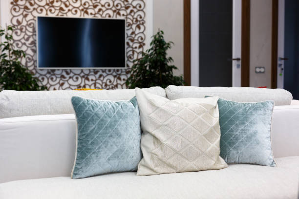 istock Red, blue and brown pillows on a white sofa, living room interior. 1205939545