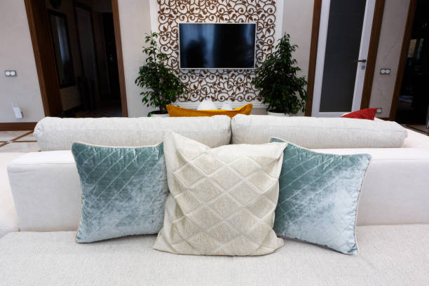 istock Red, blue and brown pillows on a white sofa, living room interior. 1205939729