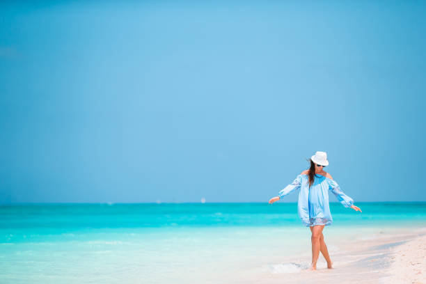 istock Young beautiful woman on tropical beach vacation 1205941275