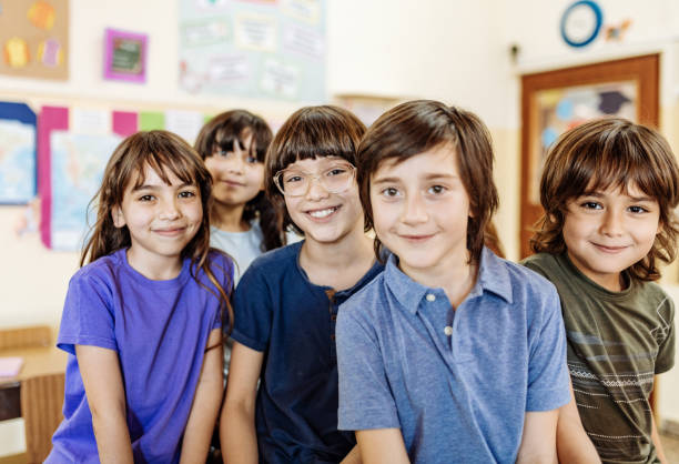 istock Portrait of diverse cute elementary school children in classroom 1205942272
