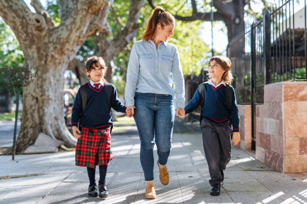 istock Mother with kids going to school 1205942600