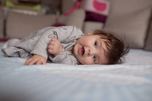 istock Baby girl on a bed 1205945035