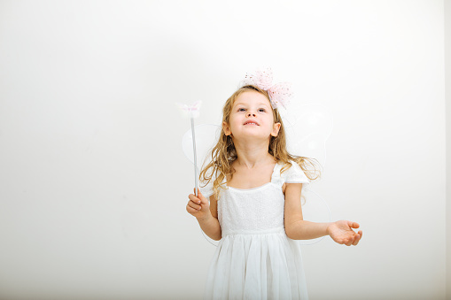 Closing ears, smiling. Pretty caucasian girl portrait isolated on white studio background with copyspace. Concept of human emotions, youth, childhood, education, sales, facial expression.