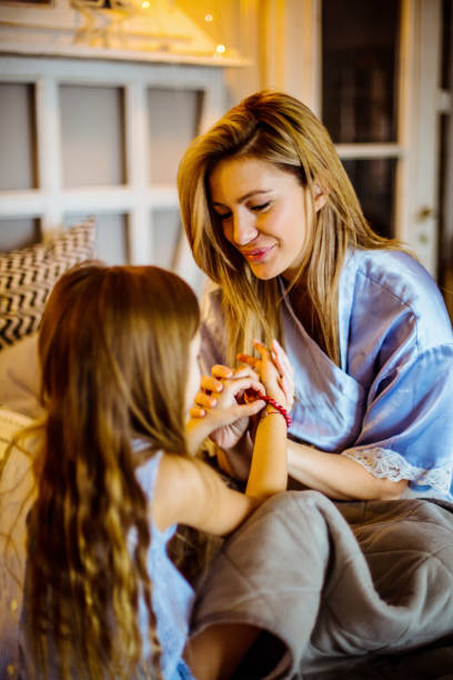 istock Mother and daughter on bed. 1205946015
