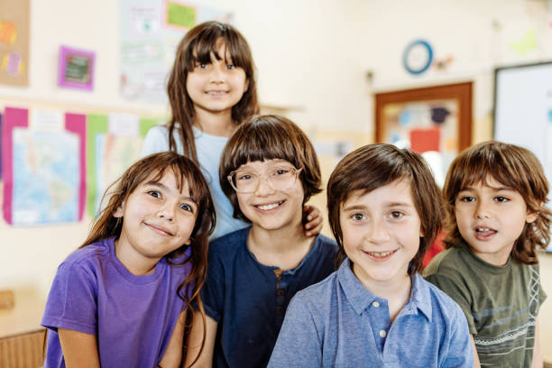istock Portrait of diverse cute elementary school children in classroom 1205946259