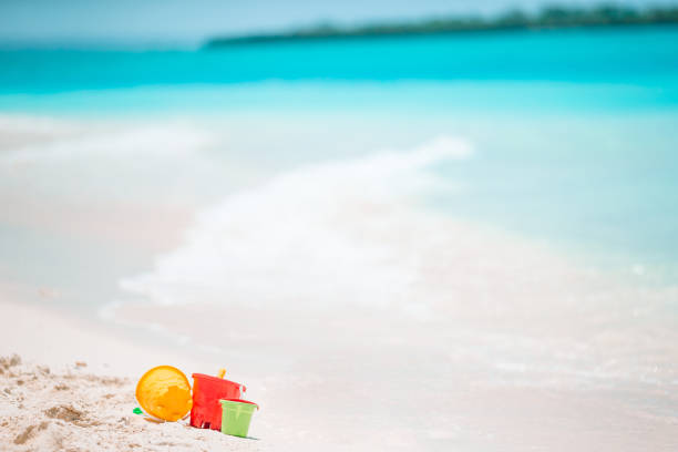 istock Beach kid's toys on white sand beach 1205946497