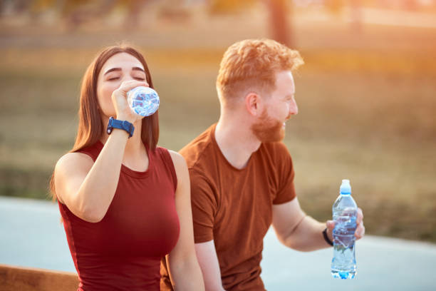 istock Modern couple making pause in an urban park during jogging / exercise. 1205948729