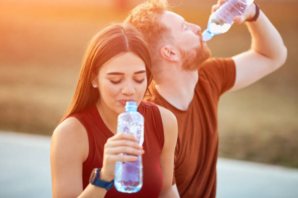 istock Modern couple making pause in an urban park during jogging / exercise. 1205948747