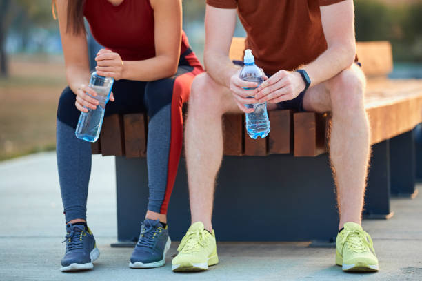 istock Modern couple making pause in an urban park during jogging / exercise. 1205948859