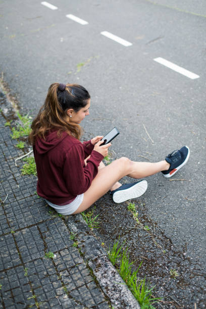 istock Sporty woman taking a running break for using smartphone 1205949107