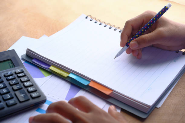 istock close up of man hand writing on notepad 1205949210