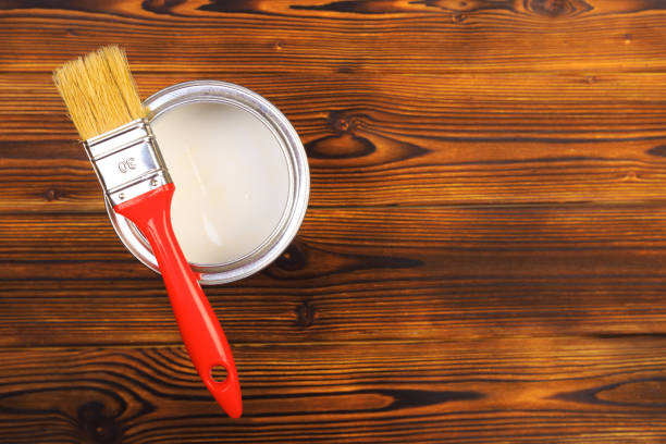 istock House renovation, paint can on the old wooden background with copy space 1205949670