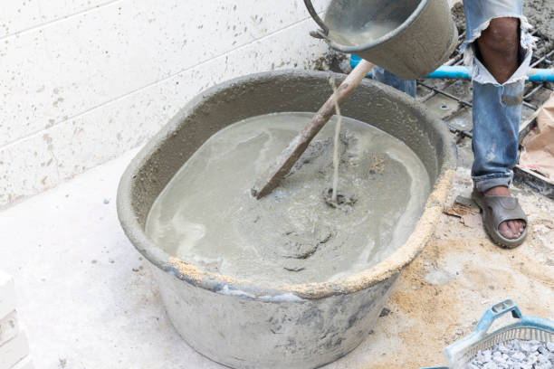 istock Concrete mixing step of sand cement and water by construction workers. 1205950372