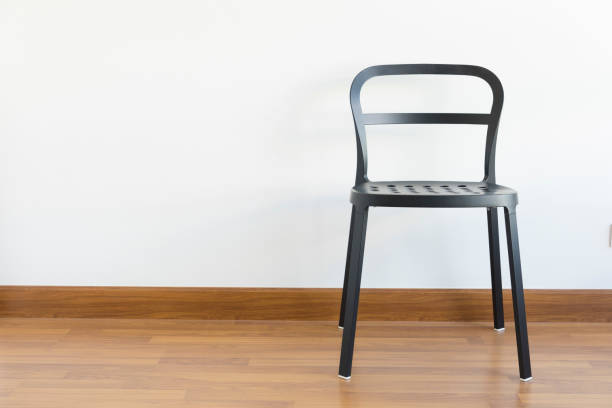 istock black metal chair in the empty white room 1205950381