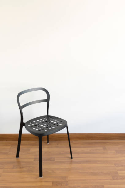 istock black metal chair in the empty white room 1205950401