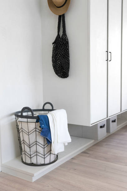 istock Laundry basket with dirty clothes in a white room. 1205950421