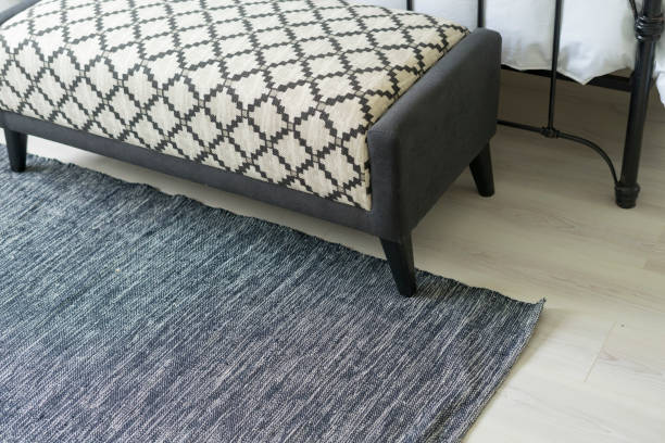 istock Carpet and blue bench in bedroom by the window. 1205950424