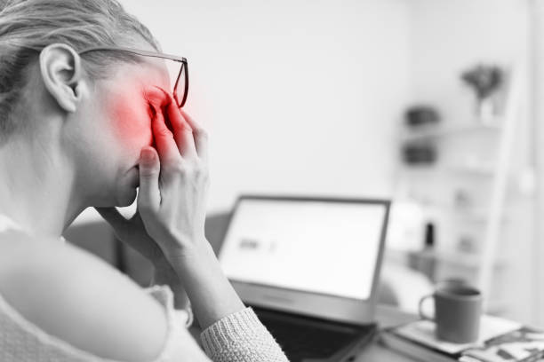 istock Woman feeling unwell, headache while working on a laptop. 1205950501