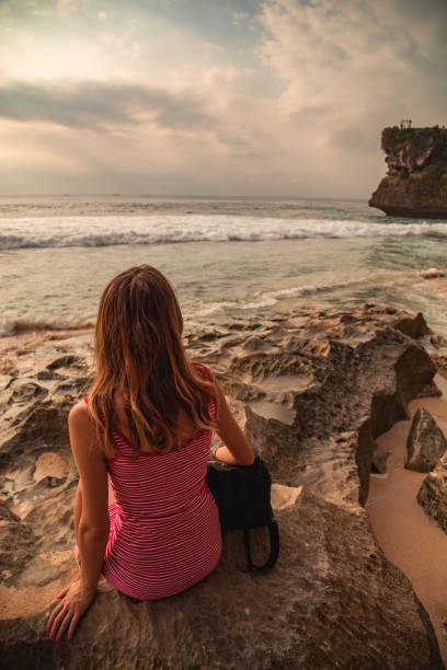 istock Woman looking at distant seascape from the beach. 1205951208