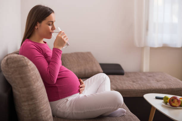 istock Pregnant  woman drinking water 1205952534