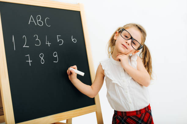 istock Child Standing by the Blackboard 1205952895