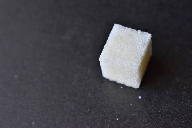 istock Square pieces of refined sugar on a black background 1205956834