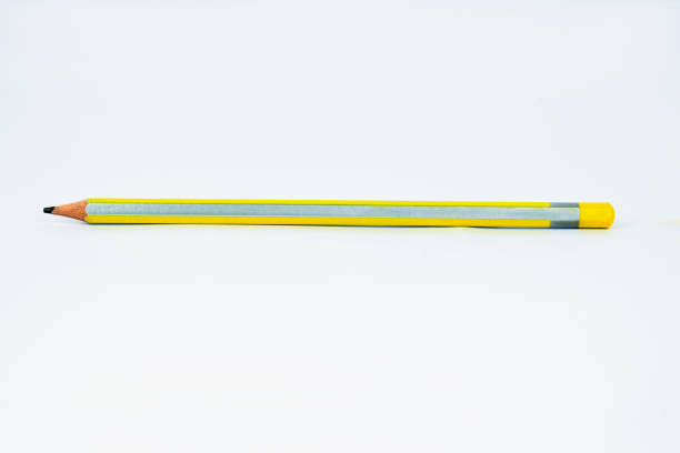 istock Single yellow-silver sharpened wood pencil crayon isolated on a white background 1205957352