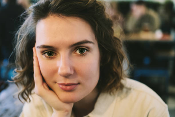 istock Young smiling confident female close up portrait in cafe 1205959148