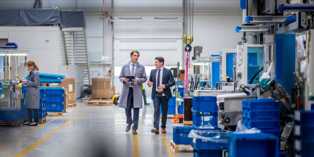 istock Manager and engineer discussing in factory 1205959380