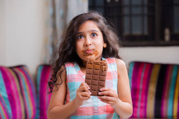 istock Girl eating chocolate stock photo 1205964521