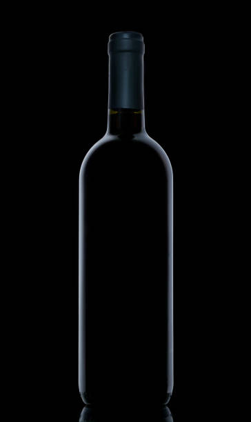 istock Wine Bottle on dark background. Outlines of wine bottle on black background. 1205964607