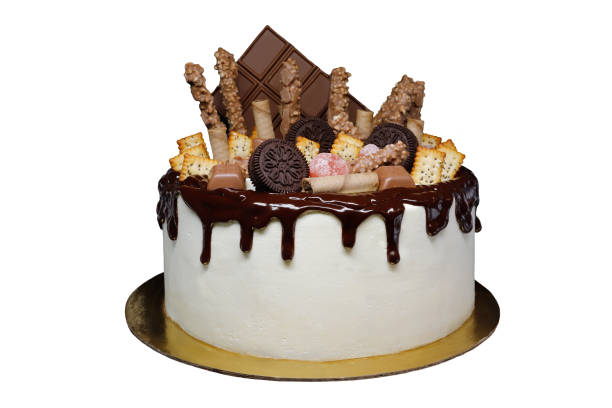 istock Beautiful cake covered with cottage cheese cream and chocolate icing, decorated with chocolate, cookies, kumquat. Isolated on white background. 1205964686