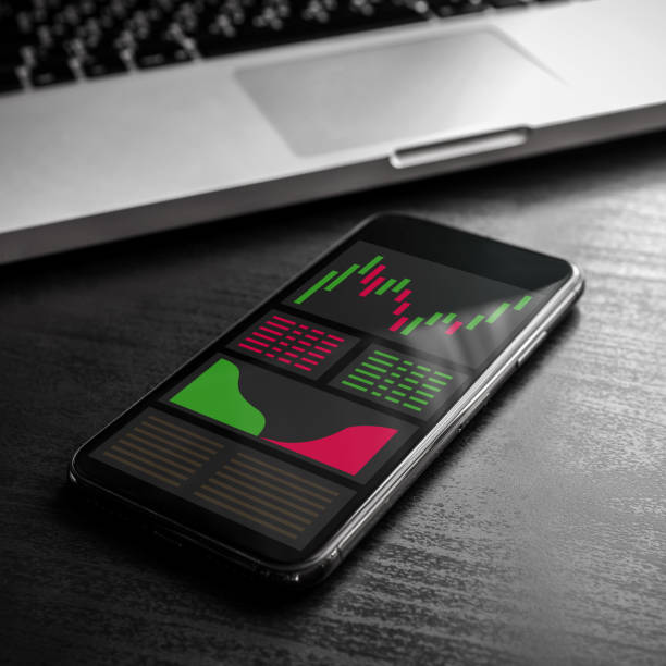 istock Stock, forex or cryptocurrency trading chart graph on mobile phone screen (close up). Modern finance exchange concept for smart investment, smartphone business application with charts, candlestick 1205965737