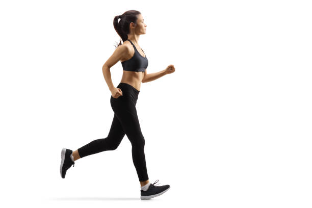 istock Young female in black leggings jogging 1205965889