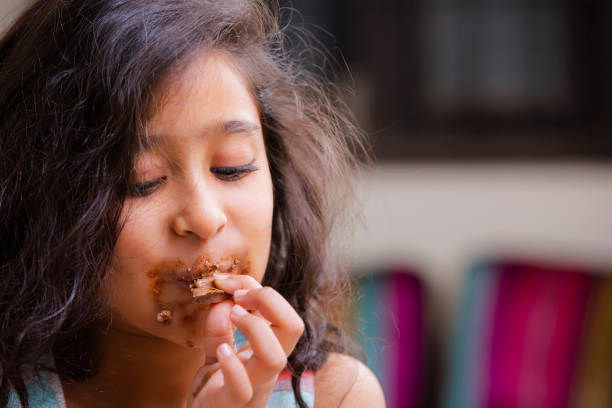 Girl eating chocolate stock photo