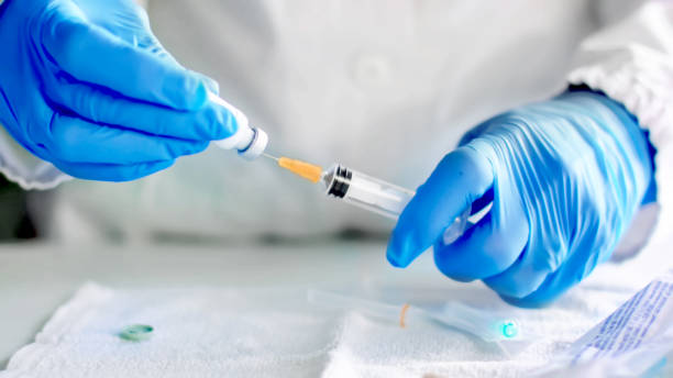 istock Doctor fills injection syringe with vaccine 1205972769