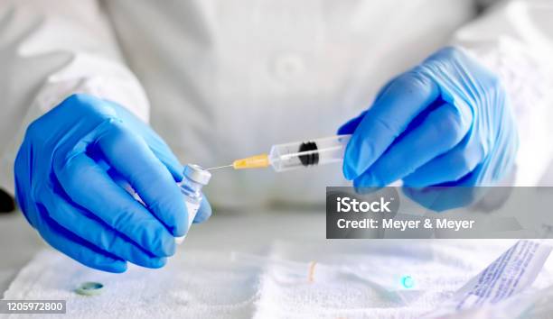 Doctor Fills Injection Syringe With Vaccine Stock Photo - Download Image Now - Vaccination, COVID-19, Medicine