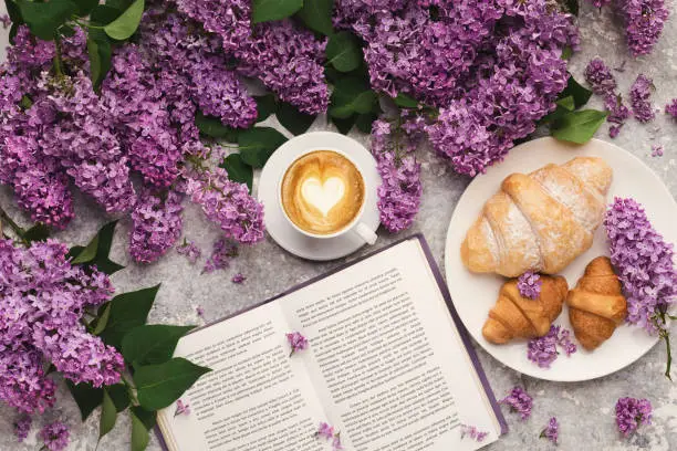 Photo of Spring background with lilac, coffee and book