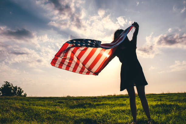 istock Gypsy woman waving USA flag 1205973041