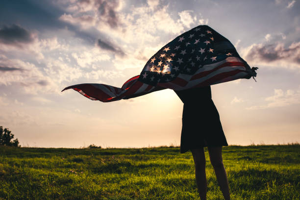istock Gypsy woman waving USA flag 1205973331