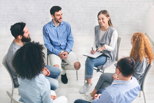 istock Diverse happy people sitting in trust circle on therapy session 1205975242