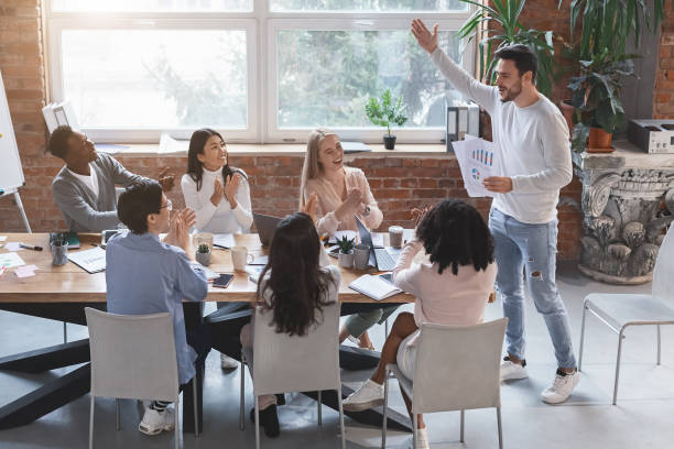 istock Young manager cheering up his young business team 1205975515
